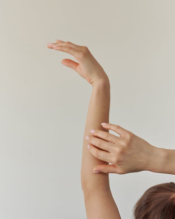 Woman in a graceful yoga pose with warm light accents.